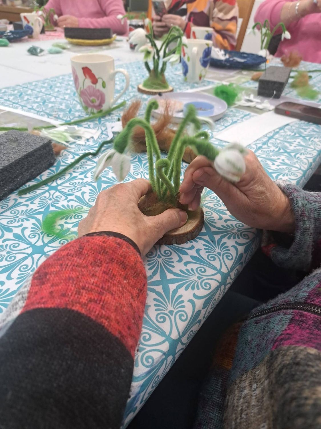 Making felted snowdrops in a needle-felting workshop